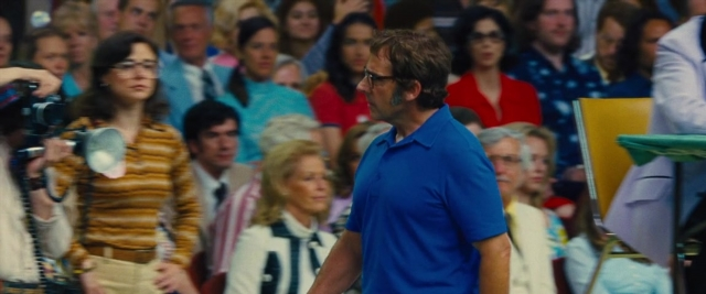 Wide shot frame from Battle of the Sexes — walking, tie, shirt