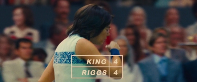 Wide shot frame from Battle of the Sexes — hand, tie, person