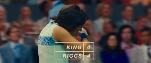 Wide shot frame from Battle of the Sexes — standing, hand, person