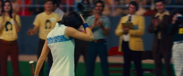 Wide shot frame from Battle of the Sexes — standing, hand, tie