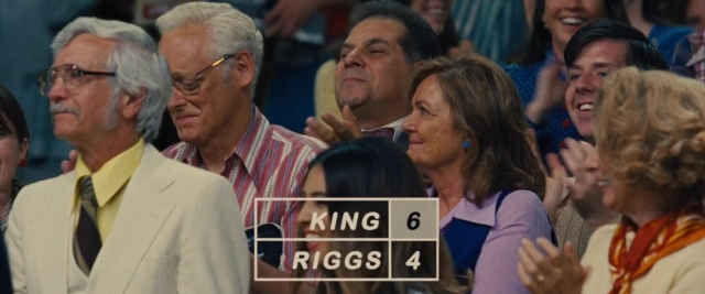 Wide shot frame from Battle of the Sexes — sitting, suit, shirt