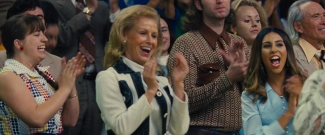 Wide shot frame from Battle of the Sexes — standing, shirt, face