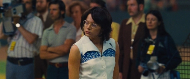 Wide shot frame from Battle of the Sexes — standing, dress, hair