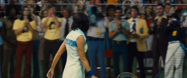 Medium shot frame from Battle of the Sexes — standing, hand, tie