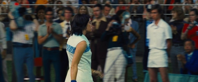 Medium shot frame from Battle of the Sexes — standing, dress, belt