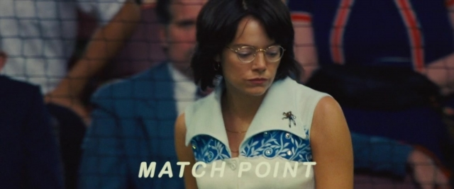 Wide shot frame from Battle of the Sexes — standing, dress, hair