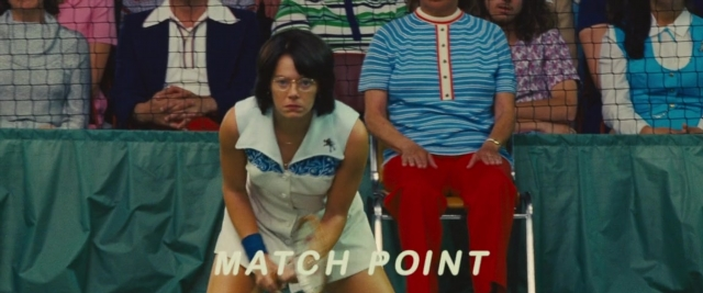 Wide shot frame from Battle of the Sexes — sitting, dress, shirt