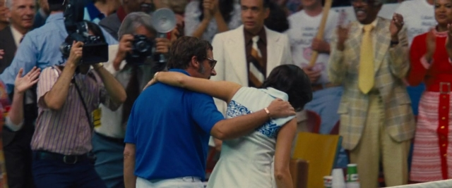 Wide shot frame from Battle of the Sexes — tie, dress, shirt