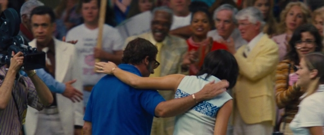 Wide shot frame from Battle of the Sexes — room, shirt, camera