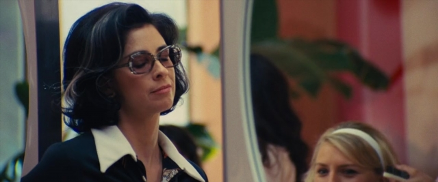 Medium shot frame from Battle of the Sexes — standing, mirror, hair