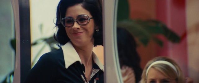 Medium shot frame from Battle of the Sexes — standing, room, mirror