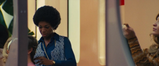 Wide shot frame from Battle of the Sexes — standing, room, dialogue