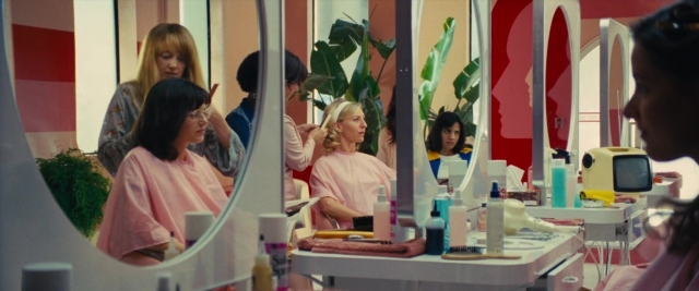 Wide shot frame from Battle of the Sexes — sitting, table, mirror