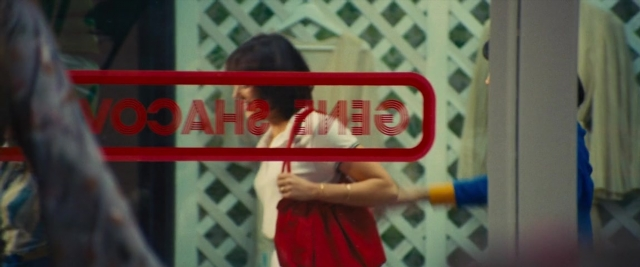 Wide shot frame from Battle of the Sexes — standing, door, dress