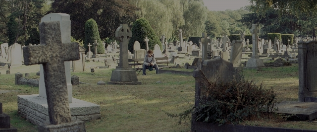 Wide shot frame from Kick-Ass — sitting, bird, person