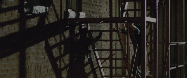 Wide shot frame from Kick-Ass — ladder, window