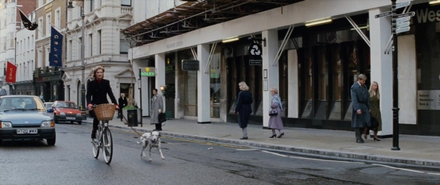 Wide shot frame from 101 Dalmatians — walking, street, dog