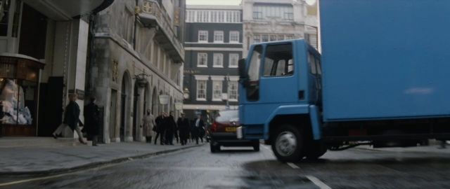 Wide shot frame from 101 Dalmatians — walking, street, car