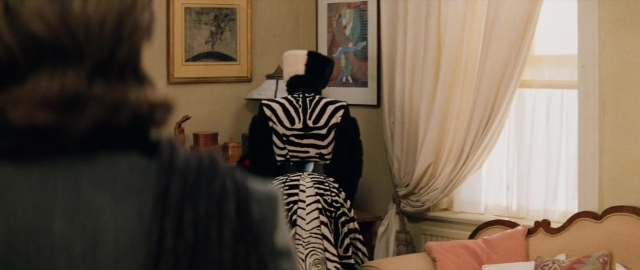 Frame from 101 Dalmatians — sitting, room, table