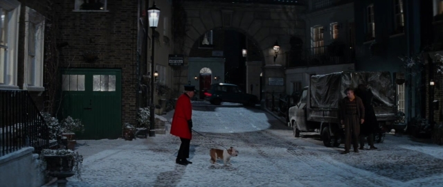 Wide shot frame from 101 Dalmatians — walking, street, hat