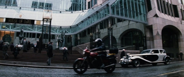Wide shot frame from 101 Dalmatians — standing, walking, street