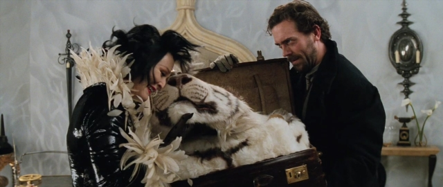 Wide shot frame from 101 Dalmatians — standing, room, table