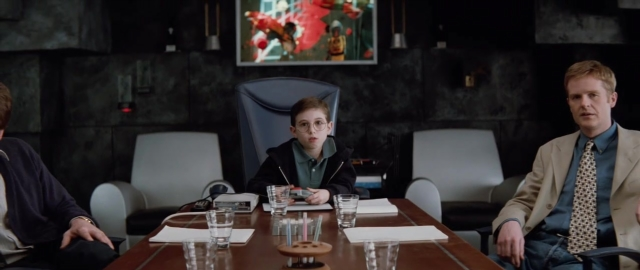 Wide shot frame from 101 Dalmatians — sitting, room, table