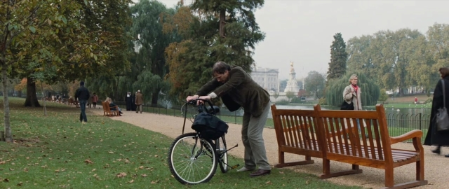 Wide shot frame from 101 Dalmatians — standing, walking, bicycle