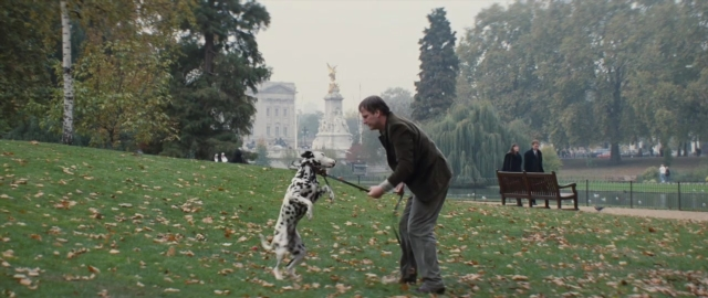 Wide shot frame from 101 Dalmatians — walking, street, dog