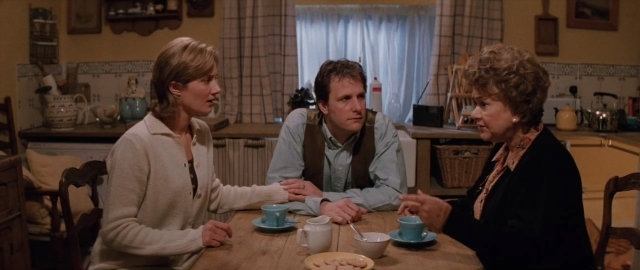 Wide shot frame from 101 Dalmatians — sitting, table, dialogue