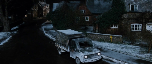 Wide shot frame from 101 Dalmatians — street, night, house