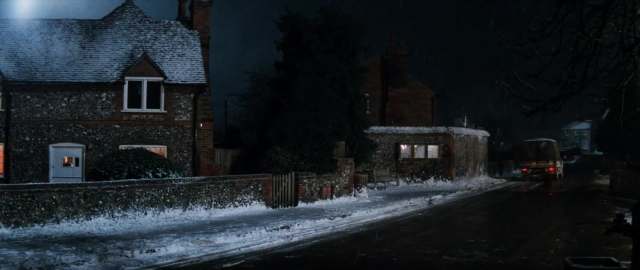 Wide shot frame from 101 Dalmatians — door, street, car