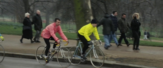 Wide shot frame from 101 Dalmatians — walking, street, hat