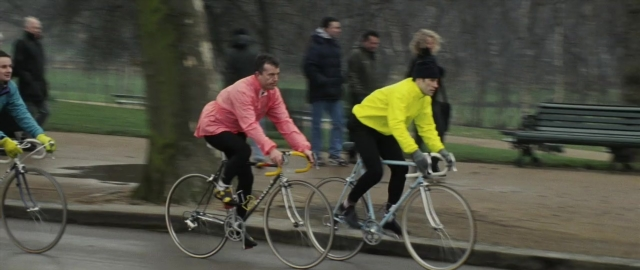Wide shot frame from 101 Dalmatians — walking, street, bicycle