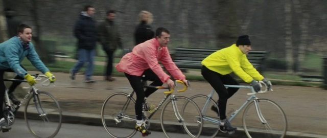 Wide shot frame from 101 Dalmatians — walking, street, bicycle