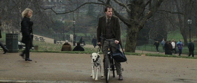 Wide shot frame from 101 Dalmatians — walking, street, dog