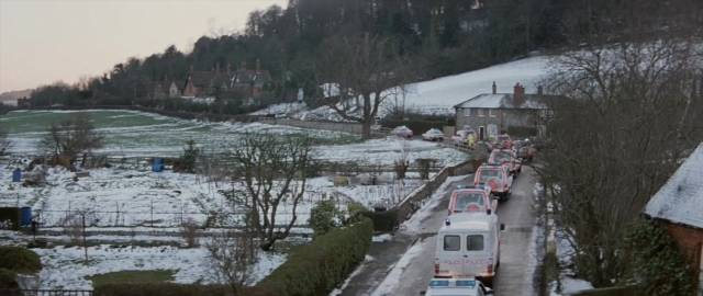 Wide shot frame from 101 Dalmatians — street, snow, land vehicle