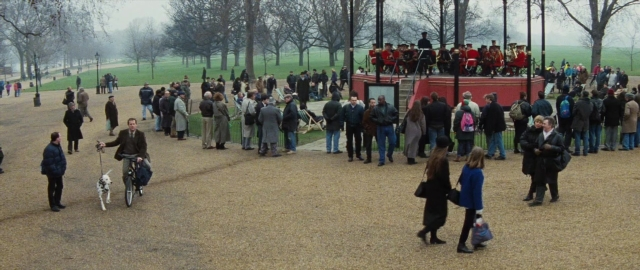 Wide shot frame from 101 Dalmatians — sitting, walking, person