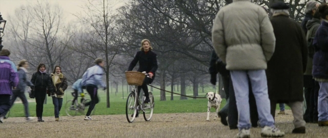 Wide shot frame from 101 Dalmatians — walking, dog, bicycle