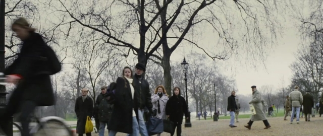Wide shot frame from 101 Dalmatians — walking, street, person