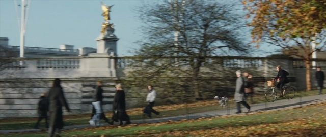 Wide shot frame from 101 Dalmatians — walking, street, coat