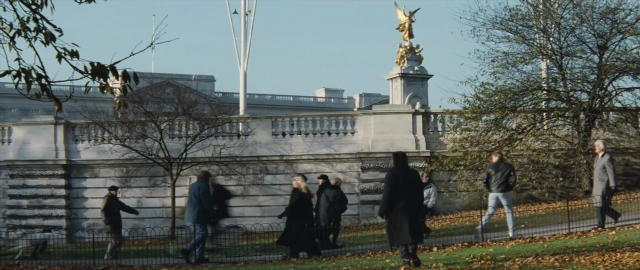 Wide shot frame from 101 Dalmatians — walking, bird, person