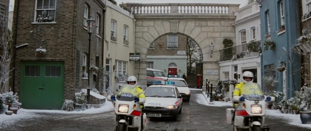 Frame from 101 Dalmatians — door, street, car
