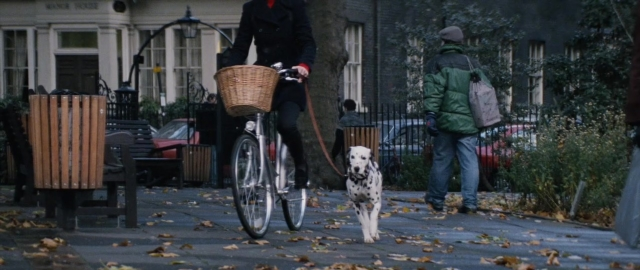 Wide shot frame from 101 Dalmatians — walking, street, dog