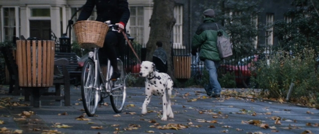 Wide shot frame from 101 Dalmatians — walking, street, dog