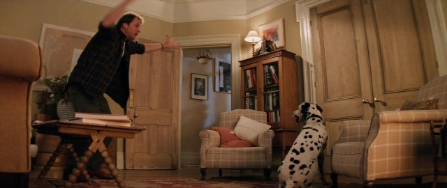 Wide shot frame from 101 Dalmatians — book, standing, dialogue