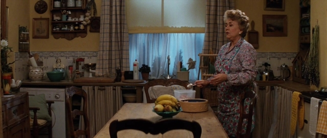 Wide shot frame from 101 Dalmatians — standing, table, kitchen