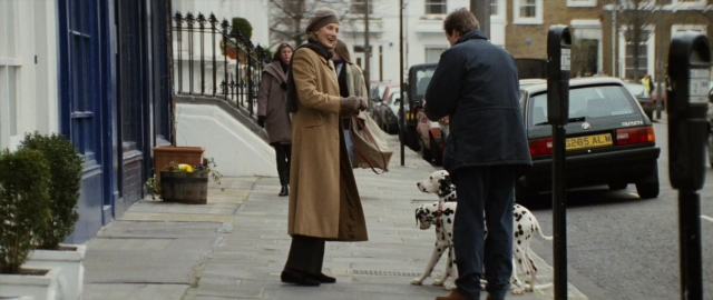 Wide shot frame from 101 Dalmatians — standing, street, hat