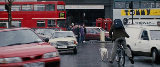 Wide shot frame from 101 Dalmatians — walking, street, dog