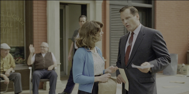 Wide shot frame from Green Book — sitting, standing, hand